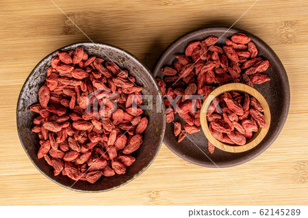 Red dried goji on light wood Red dried goji on light wood 62145289