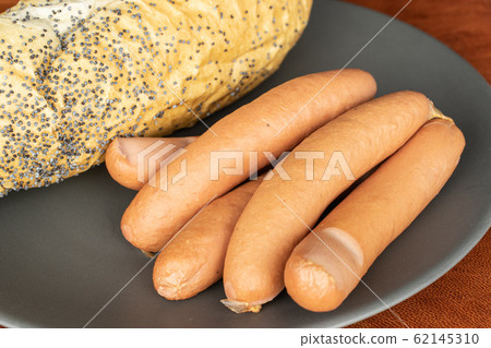 German pork sausage on cognac leather 62145310