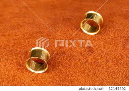 Stylish ear plug on cognac leather Stylish ear plug on cognac leather 62145392
