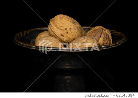 Brown tasty walnut isolated on black glass Brown tasty walnut isolated on black glass 62145394