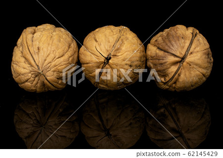 Brown tasty walnut isolated on black glass Brown tasty walnut isolated on black glass 62145429