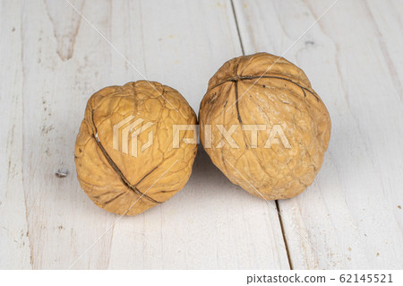 Brown tasty walnut on grey wood 62145521