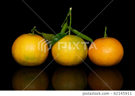Fresh orange mandarin isolated on black glass Fresh orange mandarin isolated on black glass 62145911