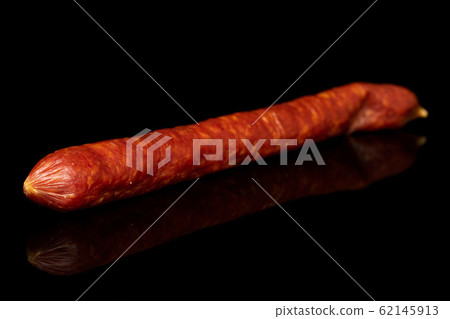 Smoked spicy sausage isolated on black glass Smoked spicy sausage isolated on black glass 62145913