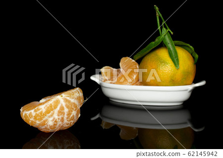 Fresh orange mandarin isolated on black glass Fresh orange mandarin isolated on black glass 62145942