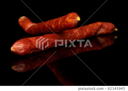 Smoked spicy sausage isolated on black glass 62145945
