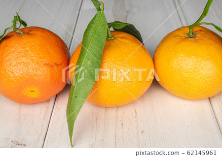 Fresh orange mandarin on grey wood Fresh orange mandarin on grey wood 62145961