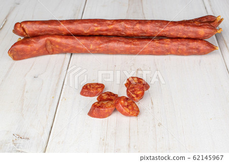 Smoked spicy sausage on grey wood Smoked spicy sausage on grey wood 62145967