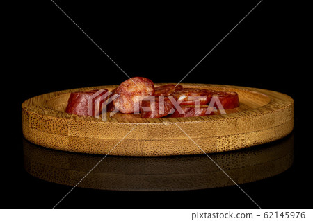 Smoked spicy sausage isolated on black glass Smoked spicy sausage isolated on black glass 62145976