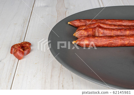 Smoked spicy sausage on grey wood Smoked spicy sausage on grey wood 62145981