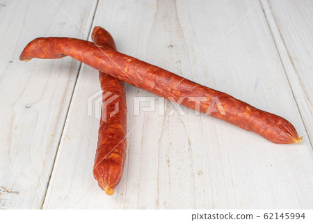 Smoked spicy sausage on grey wood Smoked spicy sausage on grey wood 62145994