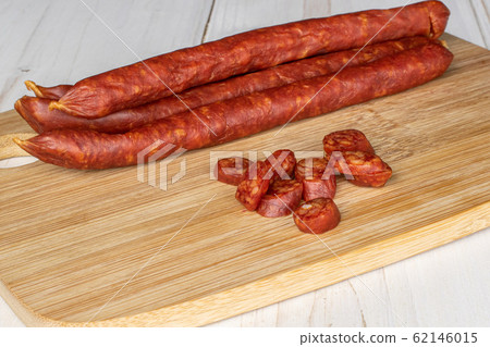 Smoked spicy sausage on grey wood Smoked spicy sausage on grey wood 62146015