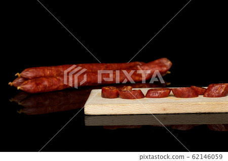 Smoked spicy sausage isolated on black glass Smoked spicy sausage isolated on black glass 62146059