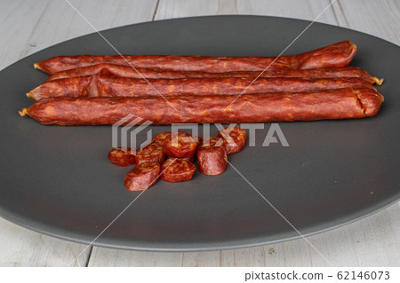 Smoked spicy sausage on grey wood Smoked spicy sausage on grey wood 62146073