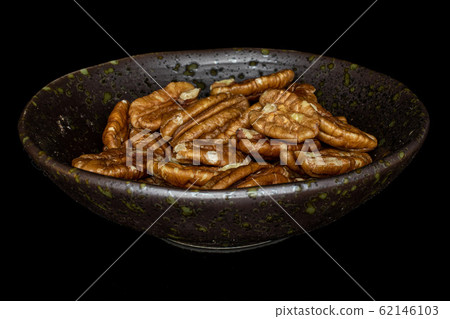 Brown pecan nut isolated on black glass Brown pecan nut isolated on black glass 62146103
