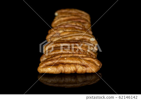 Brown pecan nut isolated on black glass Brown pecan nut isolated on black glass 62146142