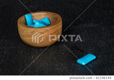 Blue chewing gum on grey stone Blue chewing gum on grey stone 62146149