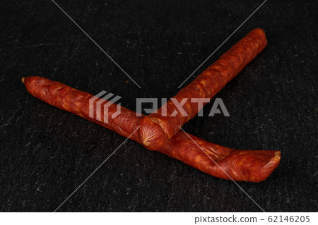 Smoked spicy sausage on grey stone Smoked spicy sausage on grey stone 62146205