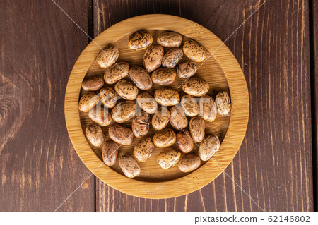 Pinto brown bean on brown wood 62146802