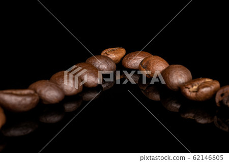 Fresh coffee bean isolated on black glass Fresh coffee bean isolated on black glass 62146805
