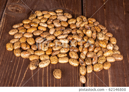 Pinto brown bean on brown wood Pinto brown bean on brown wood 62146808