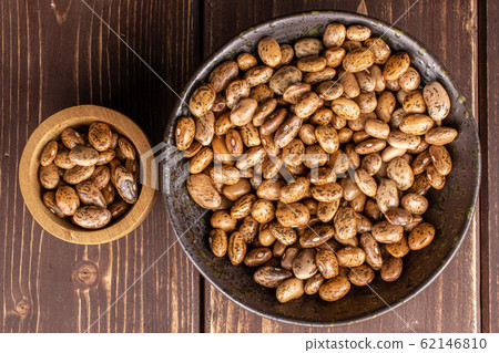 Pinto brown bean on brown wood Pinto brown bean on brown wood 62146810