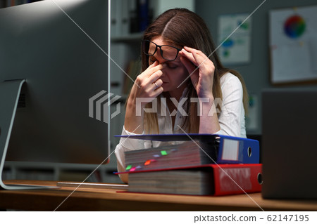 Woman took off her glasses, rubs bridge her nose 62147195