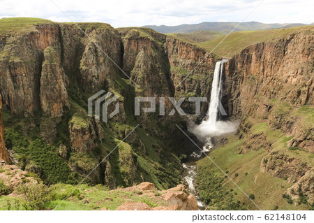 stunning waterfall running down a steap canyon 62148104