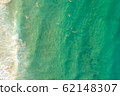 top view drone shot of green water with surfer 62148307