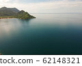 aerial shot with drone of green mountains and blue water 62148321