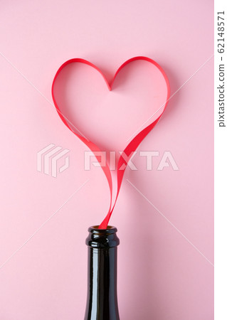 Heart of red ribbon on pink background Heart of red ribbon on pink background 62148571