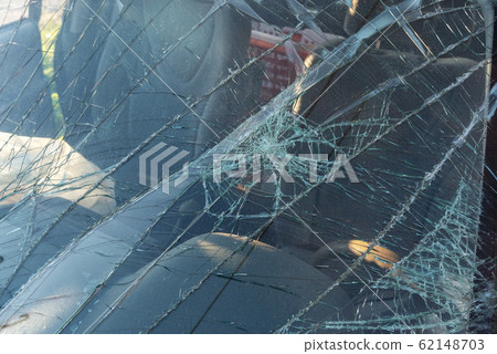 Broken windshield in a car after a crash, and driving while alcohol intoxicated. Broken windshield in a car after a crash, and driving while alcohol intoxicated. 62148703