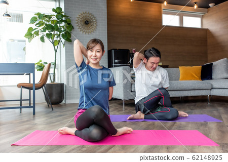 Yoga stretching in the living room at home 62148925
