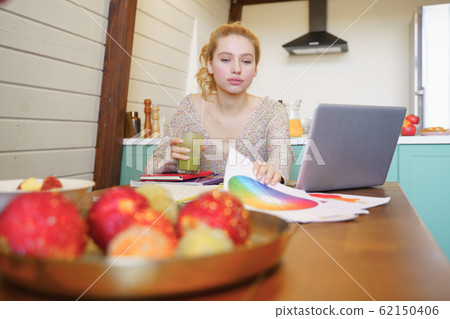 Concentrated young designer working at her project Concentrated young designer working at her project 62150406