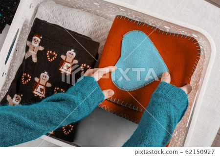 Winter time, woman holding in hands box with warm winter season things. Winter time, woman holding in hands box with warm winter season things. 62150927