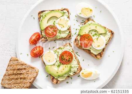 Healthy breakfast from toasts with avocado spread 62151335