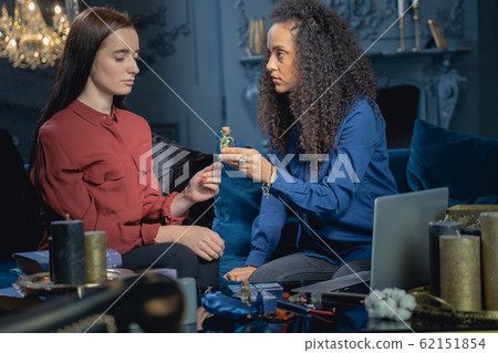 Modern young lady looking at a sorceress 62151854