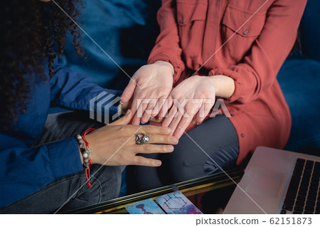Palmist looking at the Caucasian womans hands 62151873