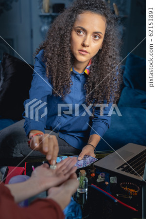 Young sorceress giving a pentagram to a woman 62151891
