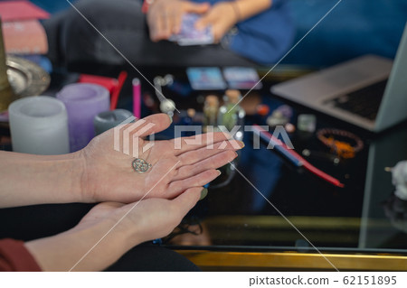 Caucasian woman sitting at a fortune-tellers session Caucasian woman sitting at a fortune-tellers session 62151895