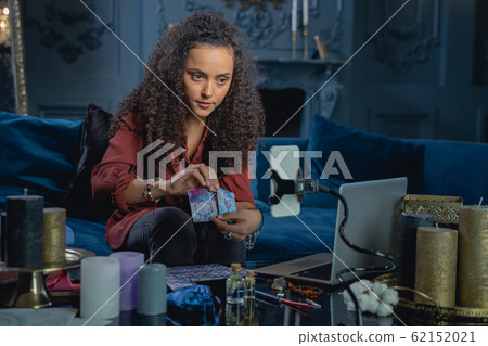 Young female fortune-teller staring at the camera 62152021