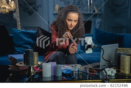 Girl holding a swastika pendant in her hand Girl holding a swastika pendant in her hand 62152496