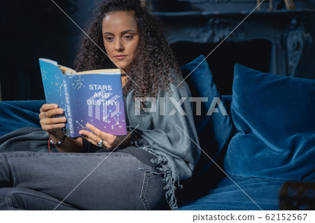 Serious girl acquiring new knowledge at home Serious girl acquiring new knowledge at home 62152567