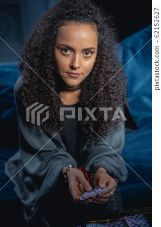Girl with cards sitting on a couch 62152627