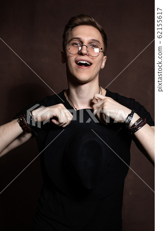 Handsome man in round glasses a black shirt Handsome man in round glasses a black shirt 62155617