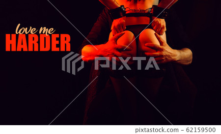 man firmly holds the sexy ass of a naked girl with her hands in handcuffs 62159500