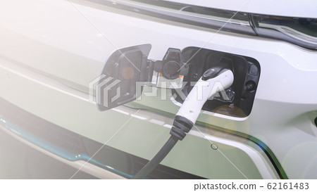 Electric car or ev is charging at station . man Electric car or ev is charging at station . man 62161483