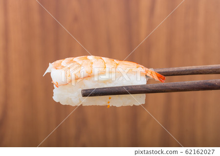 Sushi roll with black chopsticks Sushi roll with black chopsticks 62162027