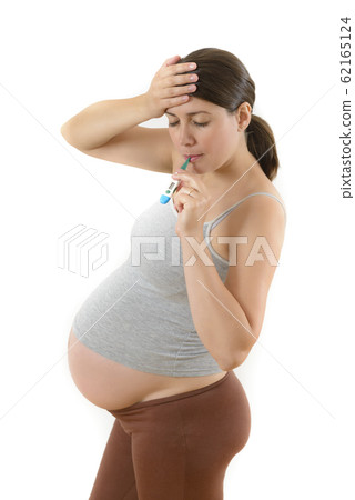 Pregnant Woman using Digital Thermometer Pregnant Woman using Digital Thermometer 62165124