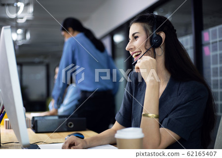 Beautiful reception call center woman speaking and 62165407